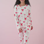 Woman modeling matching jogger set with red bow print