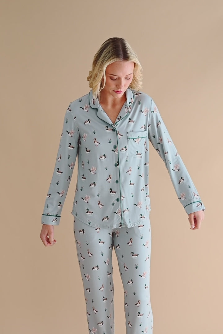 Model wearing long sleeve blue pajamas with a duck pattern 