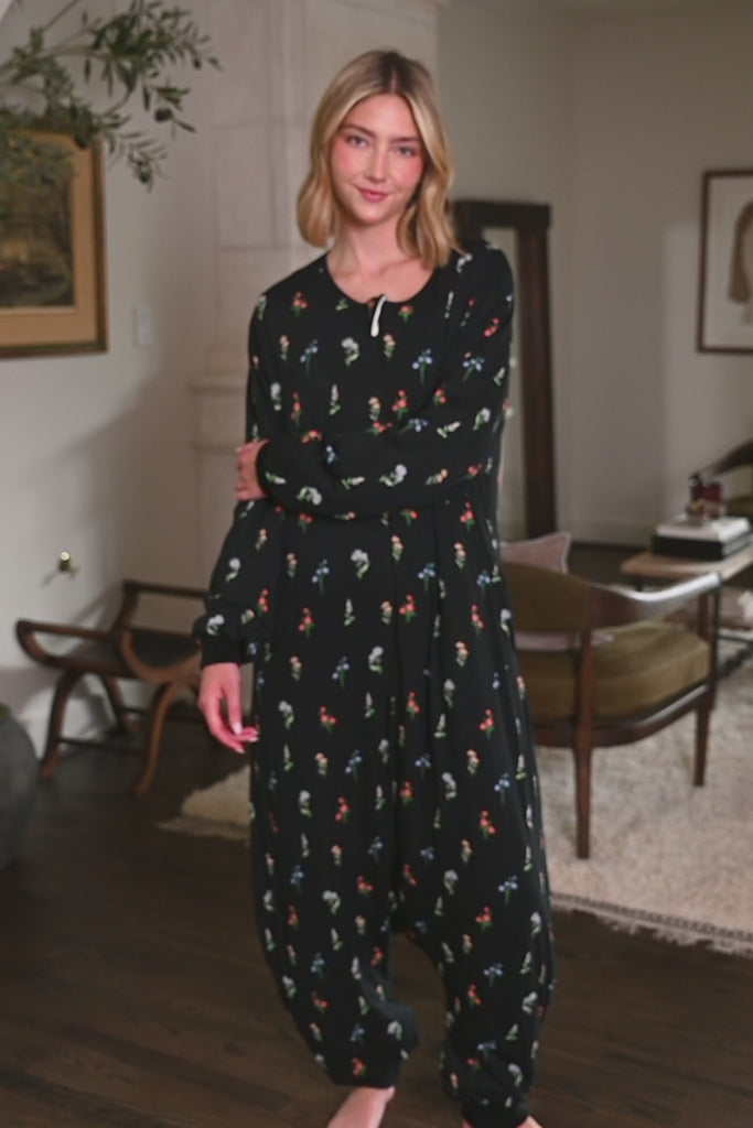 Woman modeling a black sleep sack with long sleeves and a wildflower pattern ::: Model is 5'10" wearing size S/M ///