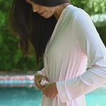 Video of woman modeling a light pink lounge robe by a pool ::: Model is 5'10" wearing size XS/S ///