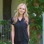 Video of woman modeling a short sleeve black pajama set with leopard print pattern outdoors  ::: Model is 5'9" wearing size XS ///