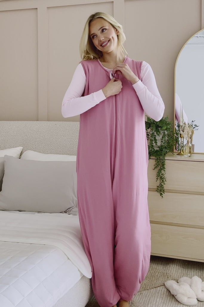 Woman modeling a deep pink sleep sack in a bedroom ::: Model is 5'9" wearing size S/M ///
