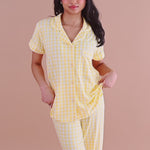 Woman modeling yellow gingham short sleeve cropped pajama set ::: Model is 5' wearing size XS ///