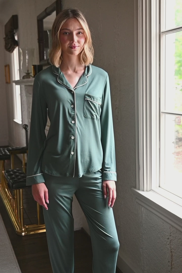 Woman modeling a long sleeve pajama in a pine green
