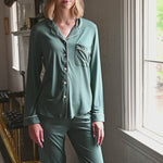 Woman modeling a long sleeve pajama in a pine green