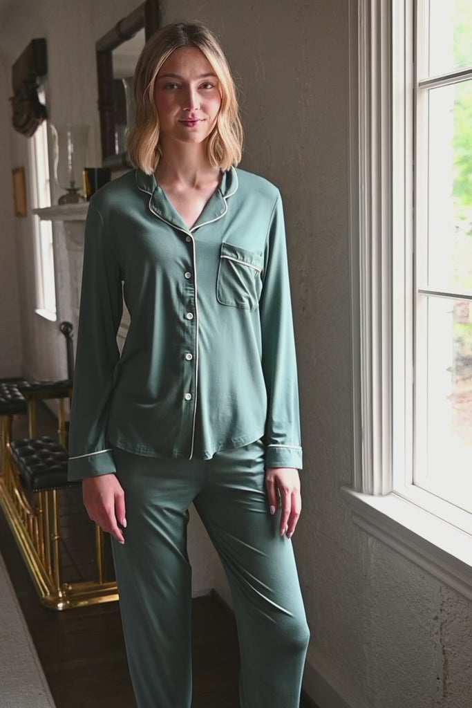 Woman modeling a long sleeve pajama in a pine green