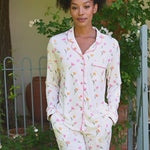 video of Woman in a white tulip pajama set standing on a porch with potted plants. ::: Model is 5'9"" wearing size S ///