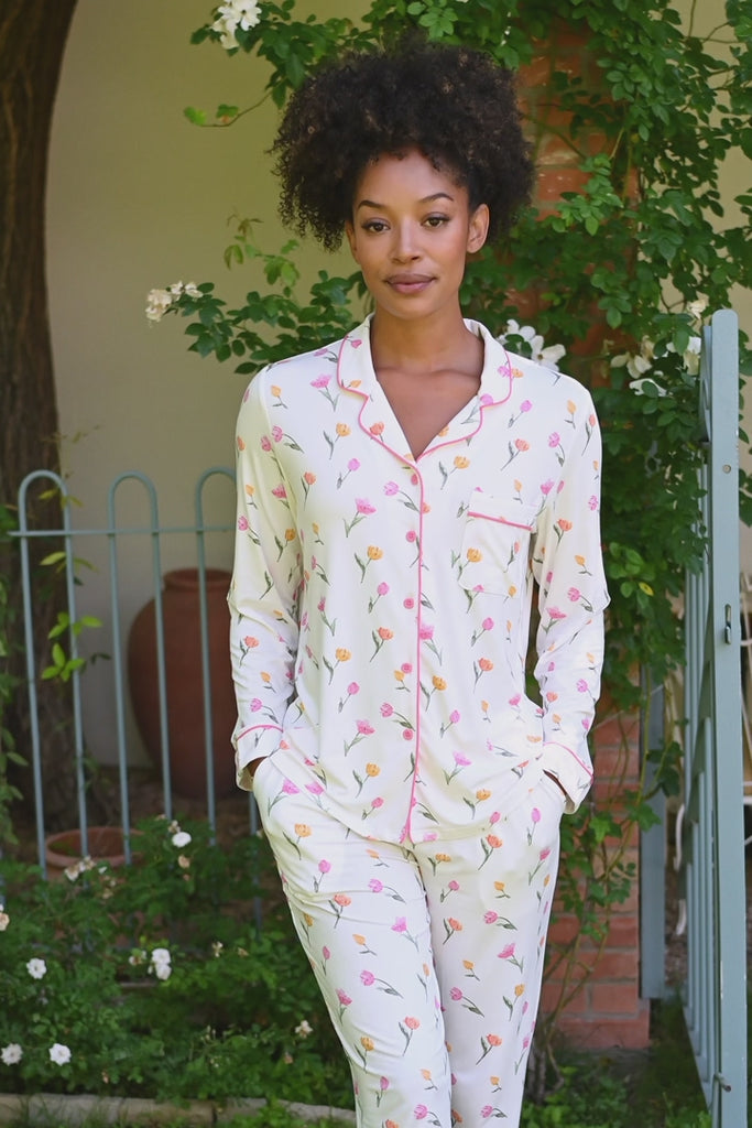 video of Woman in a white tulip pajama set standing on a porch with potted plants. ::: Model is 5'9"" wearing size S ///
