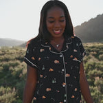 Women in Under the Stars short sleeve pajama set from Kyte Living walking around in an outdoor settng