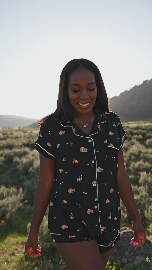 Women in Under the Stars short sleeve pajama set from Kyte Living walking around in an outdoor settng