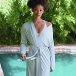 Video of model wearing a light blue lounge robe by a pool ::: Model is 5'9"" wearing size XS/S ///