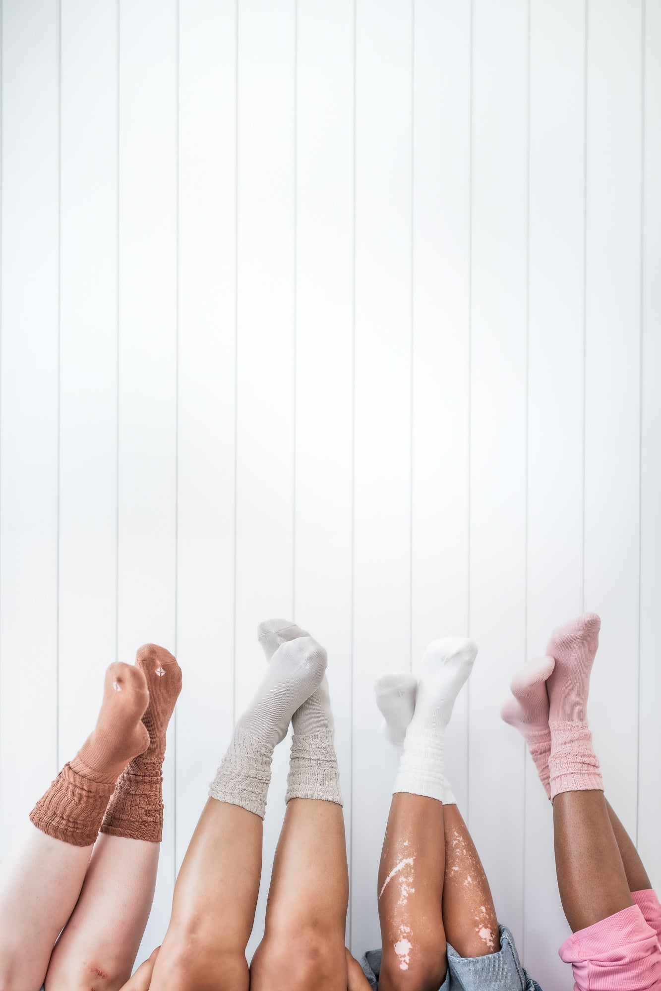Models wearing Scrunch Socks in Latte, Oat, Cloud and Blush
