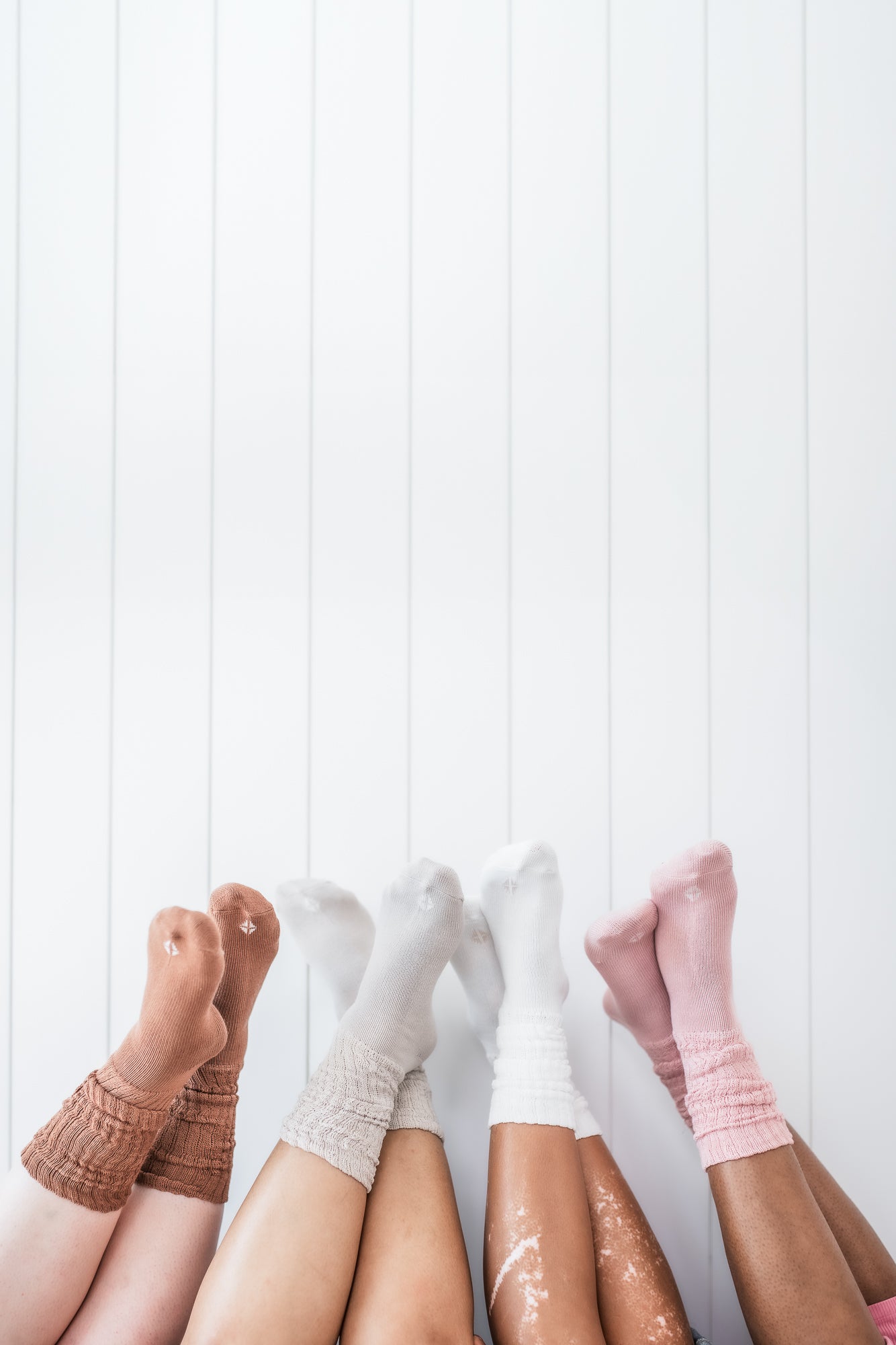 Models wearing the Kyte Scrunch Socks in Latte, Oat, Cloud and Blush