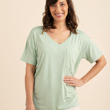 Smiling woman with hand on hip modeling the Bamboo Women's Relaxed Fit V-Neck in Basil ::: Model is 5'5" wearing size S ///