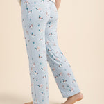 Light blue pajama pants with duck pattern worn by a person on a beige background
