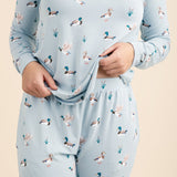 Light blue pajama set with duck pattern worn by a person on a beige background