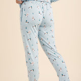 Light blue pajama set with duck pattern worn by a person on a beige background
