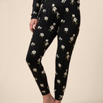 Close up on jogger bottom with a black magnolia print 