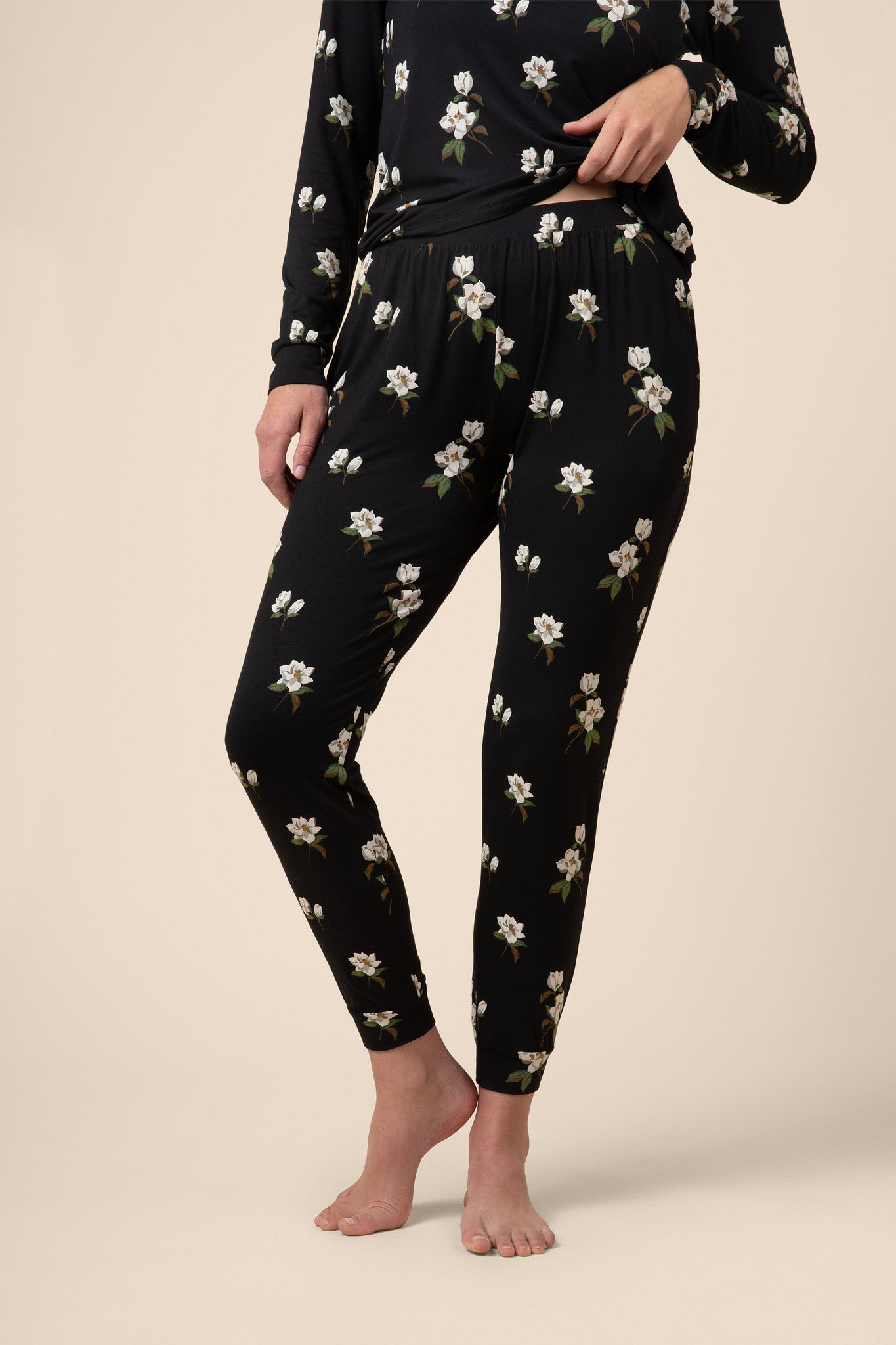 Close up on jogger bottom with a black magnolia print 