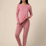 Woman wearing a pink jogger pajama set against a beige background ::: Model is 5'9" wearing size S ///

