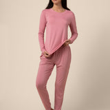 Woman wearing a pink jogger pajama set against a beige background ::: Model is 5'9" wearing size S ///
