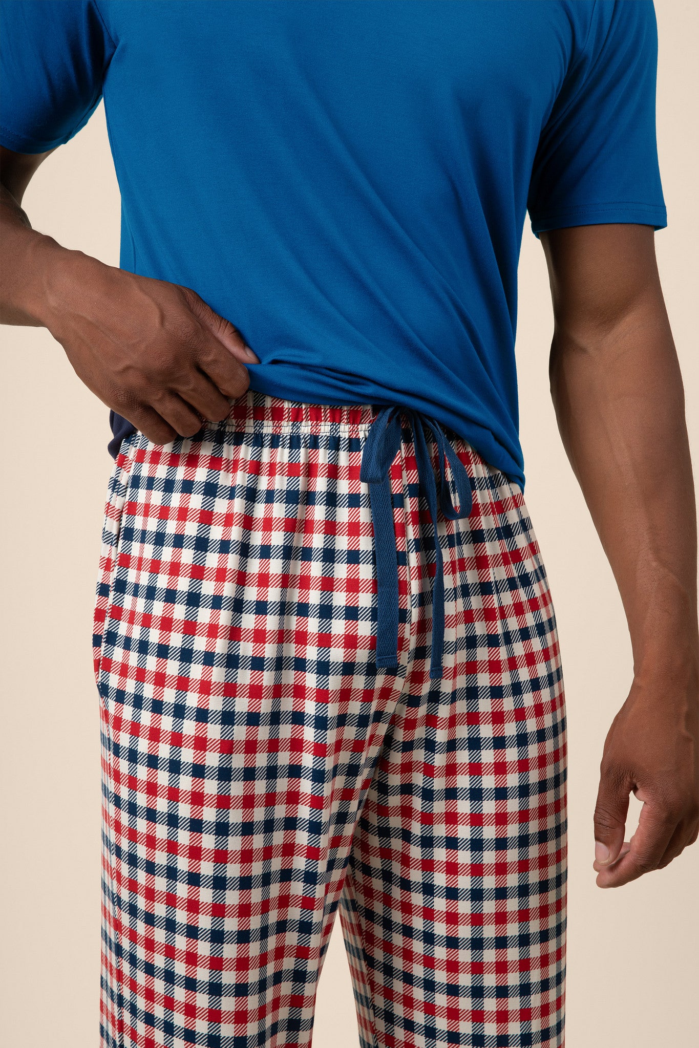 Close up of the  drawstring and waistband on the Men's Lounge Pants in Patriotic Gingham while being worn by a model 