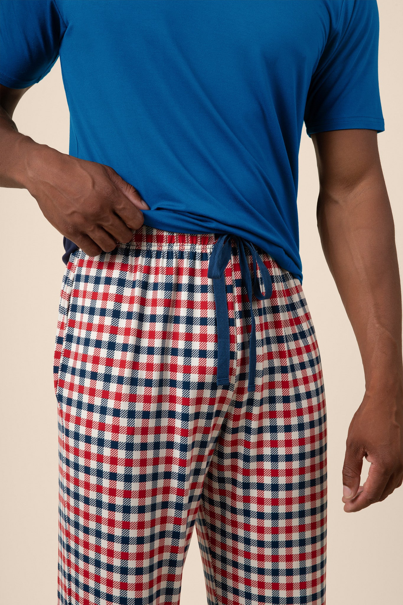 Close up of the  drawstring and waistband on the Men's Lounge Pants in Patriotic Gingham while being worn by a model 
